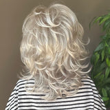 All over cascading wavy layers and a textured bang wig